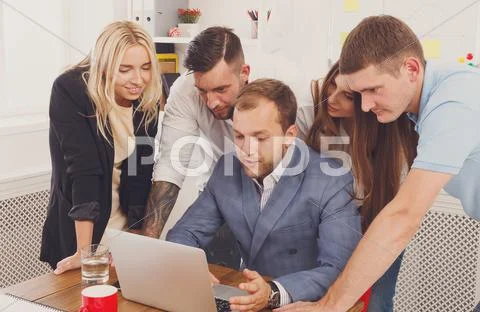 Happy business people team together near laptop in office Stock Photos