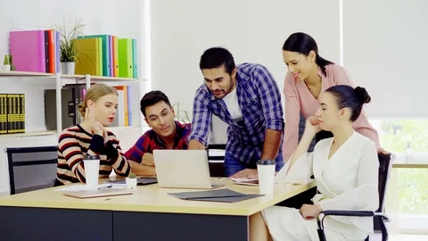 Happy business teamwork cheerful while looking laptop startup office Stock Footage 96318331