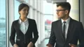 The happy businessman and a businesswoman walking in the office. slow motion 4k or 4k+ Resolution