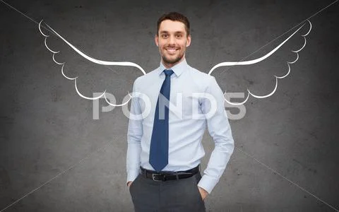 Happy businessman with angel wings over gray Stock Photos