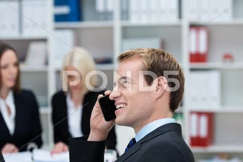 Happy businessman chatting on his mobile phone Stock Photos