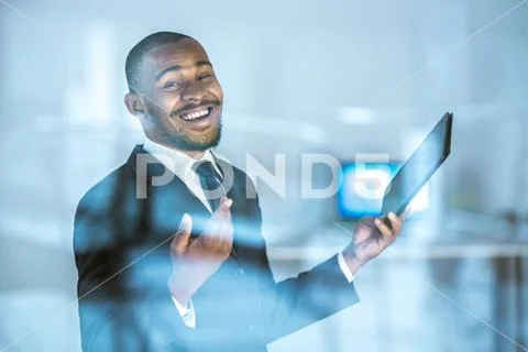 The happy businessman gesture with a tablet over the window Stock Photos