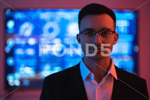 The happy businessman in glasses on the screen background Stock Photos