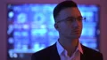 The happy businessman in glasses standing on the display background 4k or 4k+ Resolution