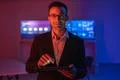 The happy businessman in glasses working with a tablet in the dark room Photo
