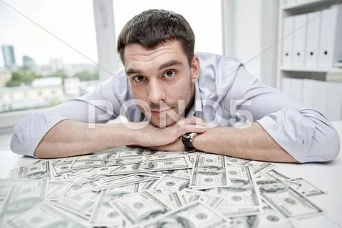 Happy businessman with heap of money in office Stock Photos