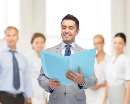 Happy businessman with open folder Stockfoto's