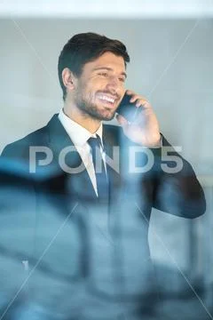 The happy businessman phone and stand near the window Stock Photos