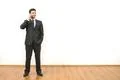 The happy businessman phones on the white wall background Photo