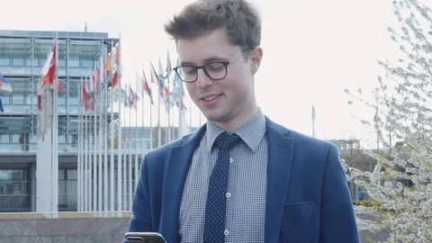 Happy businessman sends a message using a smartphone Video stock 78976927