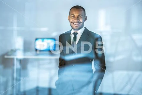 The happy businessman stand near the glass Stock Photos