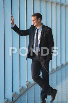 The happy businessman stand near the panoramic window Stock Photos