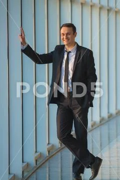 The happy businessman stand near the panoramic window Stock Photos