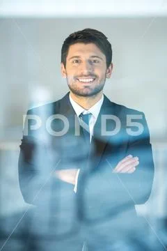 The happy businessman stand near the window Stock Photos