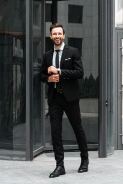Happy businessman standing in front of building Stock Photos