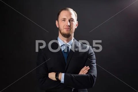 Happy businessman in suit over black background Stock Photos