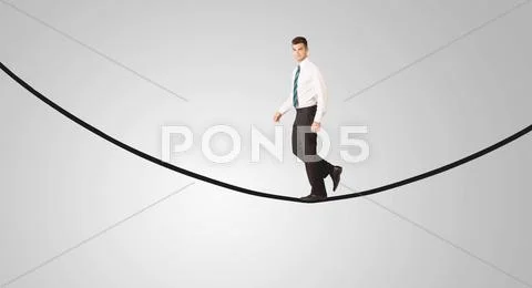 Happy businessman walking on rope Stock Photos