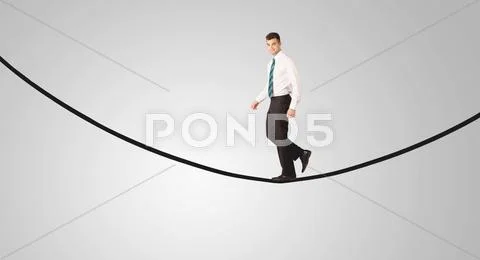 Happy businessman walking on rope Stock Photos