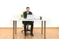 The happy businessman working at the desktop on the white wall background Photo