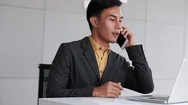 Happy Businessman Working On Laptop In Office And Answer Incoming Call Via Sm Stock Footage