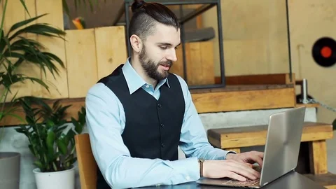 Happy businessman working on notebook in the cafe, steadycam shot Stock Footage 73301078
