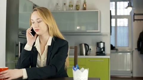 Happy businesswoman chatting on cellphone during her break, steadycam shot Stock Footage