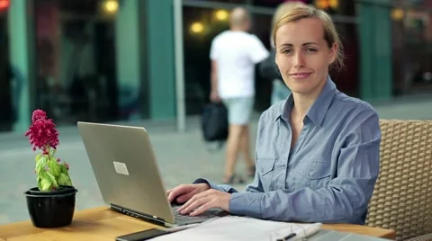Happy businesswoman with laptop and documents in the city HD Stock Footage