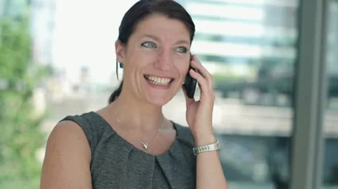 Happy businesswoman talking on cellphone, steadicam shot HD Stock Footage