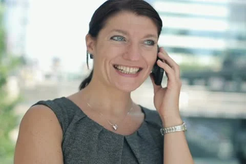 Happy businesswoman talking on cellphone, steadicam shot NTSC Stock Footage