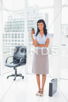 Happy businesswoman texting on her mobile phone Stock Photos