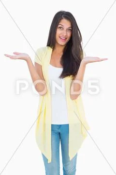 Happy casual woman shrugging her shoulders Stock Photos