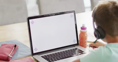 Happy caucasian boy sitting at table and using laptop with copy space, slow Stock Footage 336483135