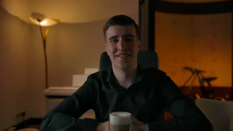 Happy caucasian man talking via web camera during online call with coffee Stock Footage 143676493