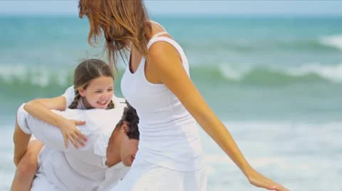 Happy Caucasian parents daughter enjoying holiday together walking on beach   Stock Footage