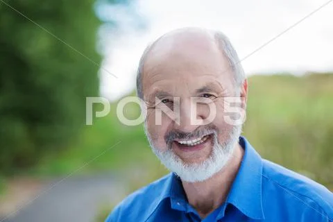 Happy caucasian retired bearded man, outdoors Stock Photos