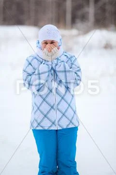 Happy caucasian woman portrait with warming frozen hands in winter Stock Photos