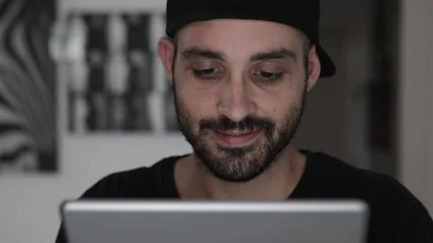 Happy caucasian young man using digital tablet computer at home Stock Footage 160917942