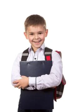 Happy cheeerful school boy hugging a black tablet folder in his hands. Standing Stock Photos