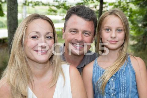 Happy cheerful and loving family with young girl Stock Photos