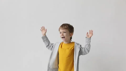 Happy cheerful boy joyfully jumping waving his arms, celebrating victory. Stock Footage 169011550