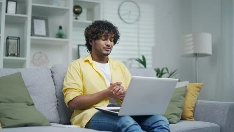 Happy cheerful guy communicates online with family or friends via video call  Stock Footage 235489429