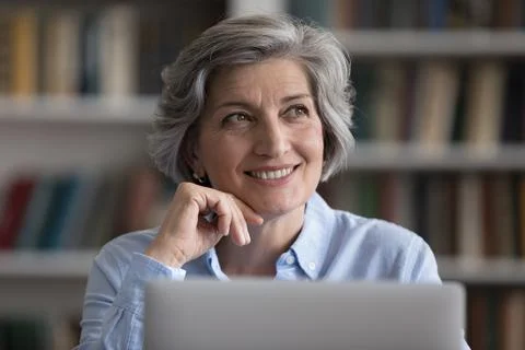 Happy cheerful senior business lady thinking of project future vision Stock Photos