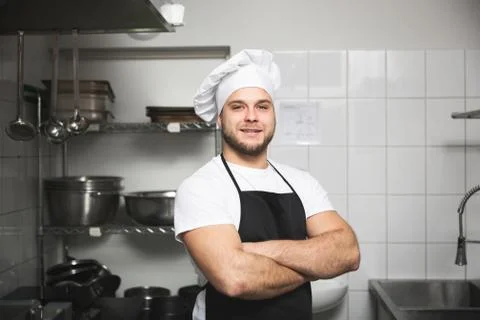 Happy chef standing in kitchen Foto stock