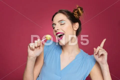 Happy Cherming Young Woman With Lollipop Dancing And Singing