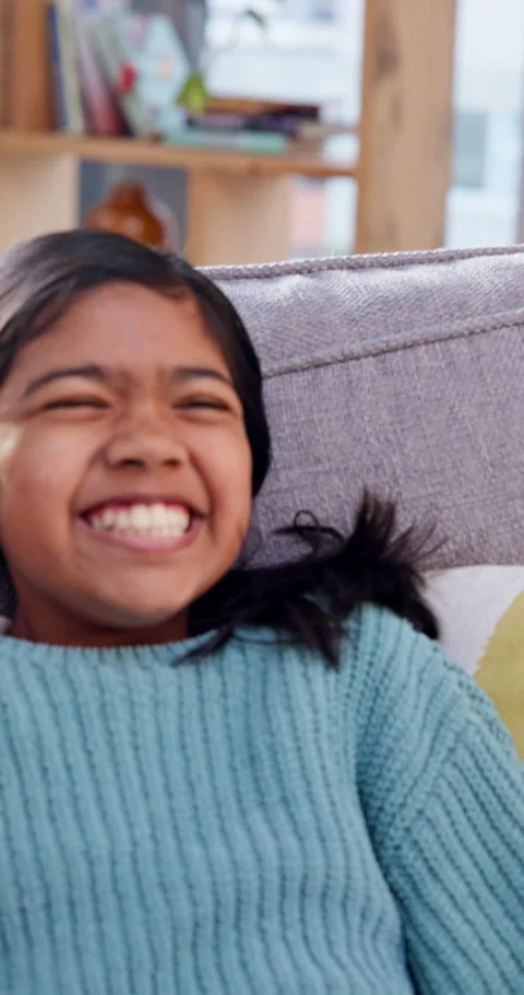 Happy, child and jump on sofa with remote for watching tv, funny movie selection Stock Footage 340385251