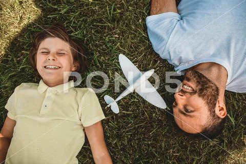 Happy child and satisfied dad during relax Stock Photos