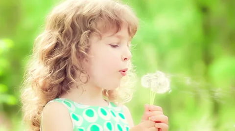 Happy child blowing dandelion in spring outdoors. Slow motion Stock Footage 46914292