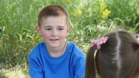 Happy child blowing soap bubbles in spring park. Slow motion Stock Footage
