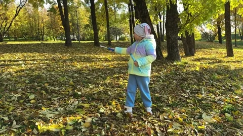 Happy child blowing soap bubbles in park Stock Footage 288387858