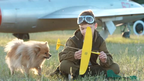 Happy child boy pilot play together pet dog, fun adventure game launch plane fly Stock Footage 132454763